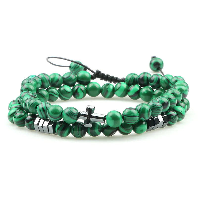 Green beaded bracelet with black accents on a white background